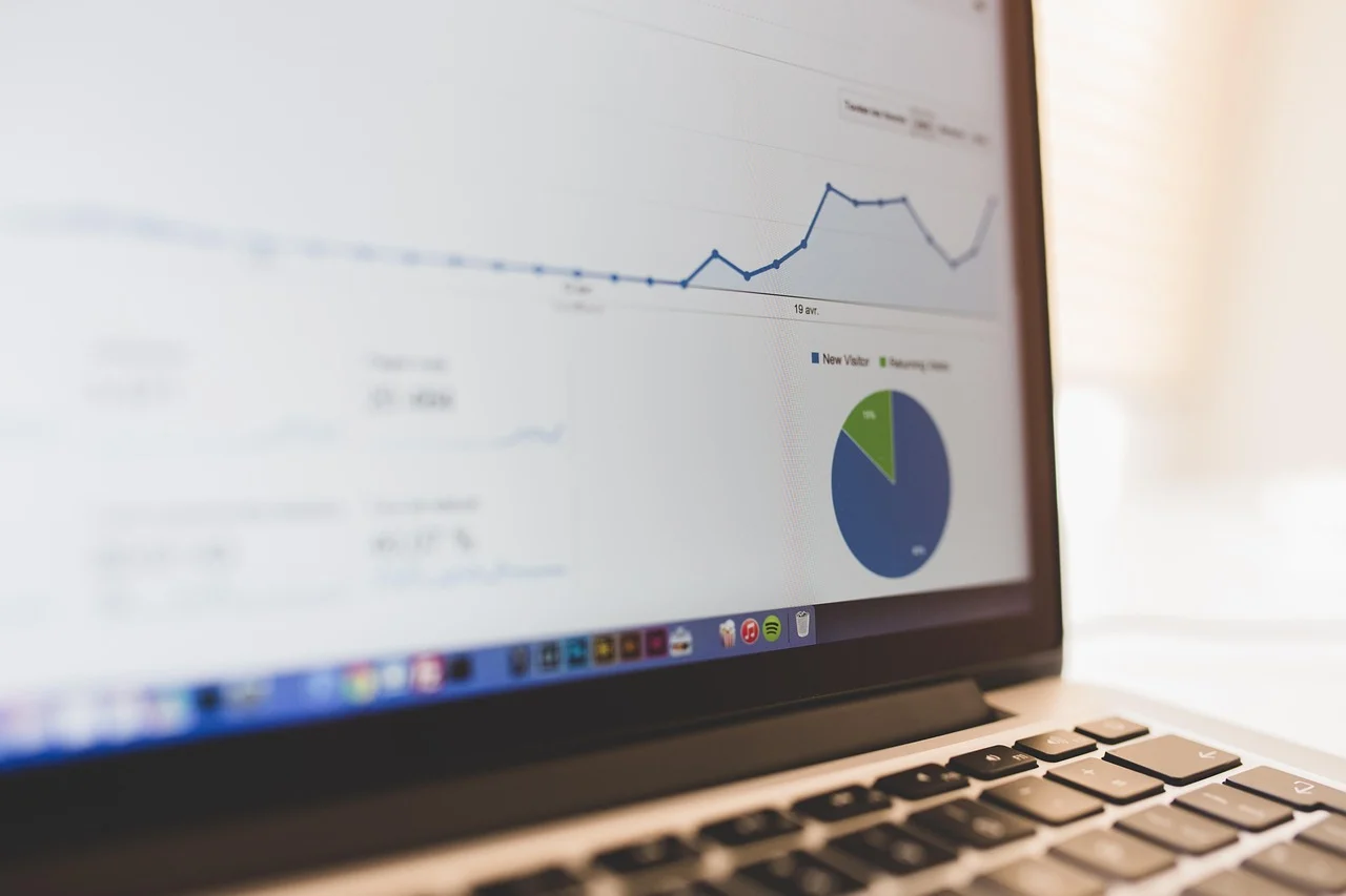 A person analyzing a graph showing fixed vs variable costs on a laptop