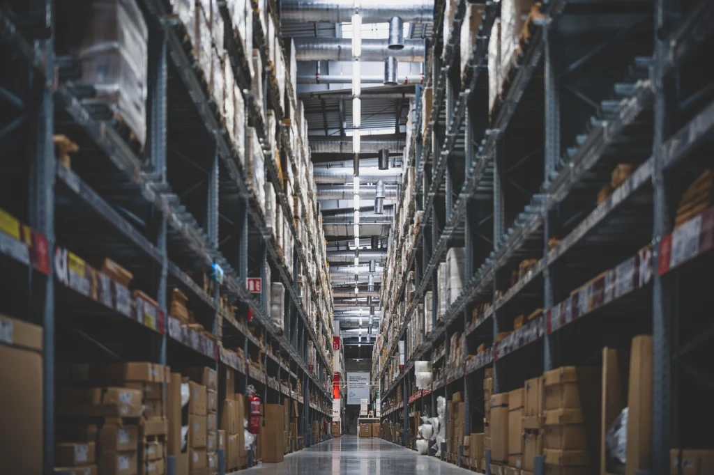Worker in an ecommerce warehouse handling inventory boxes